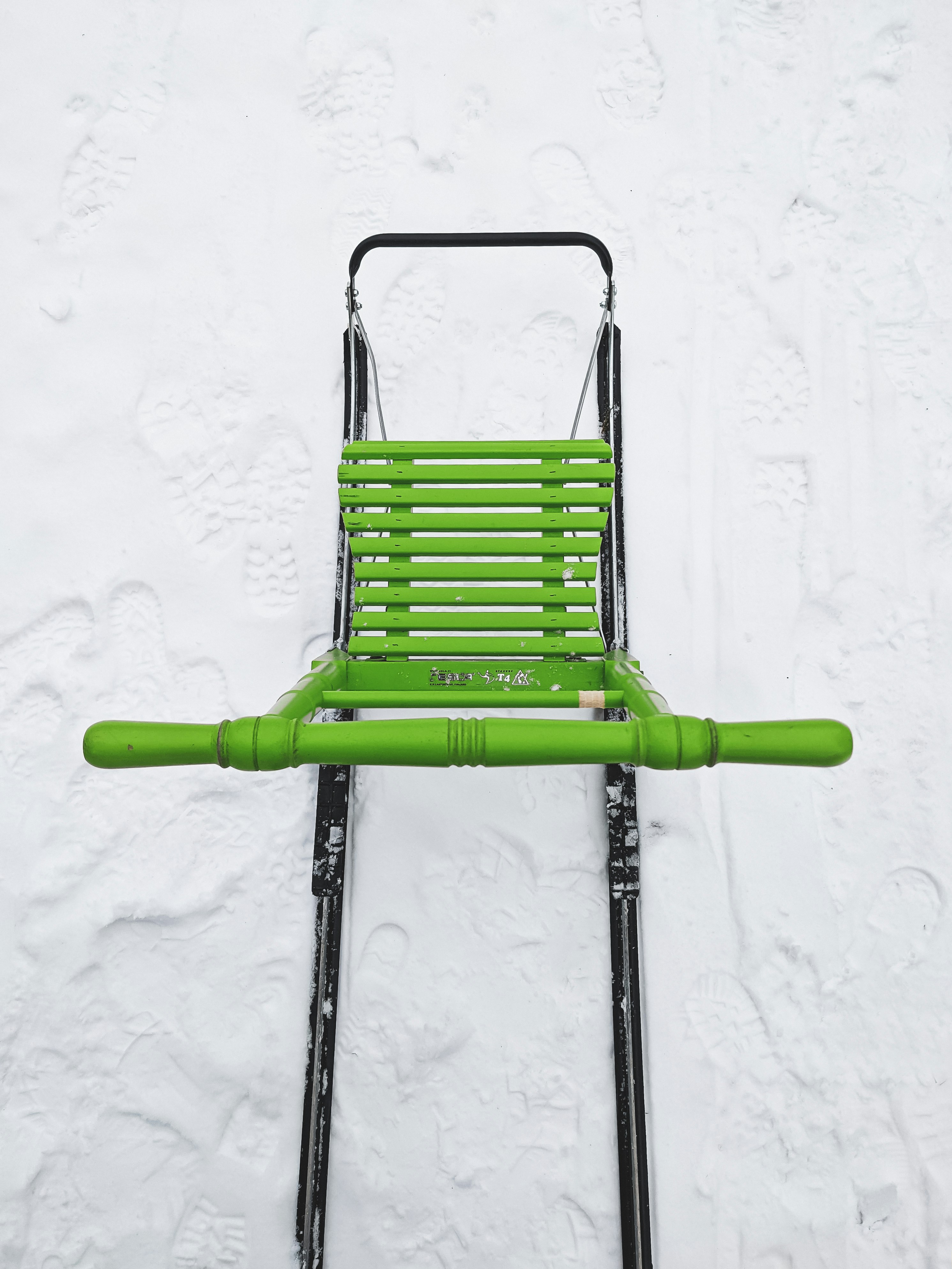 green and black folding chair on white snow